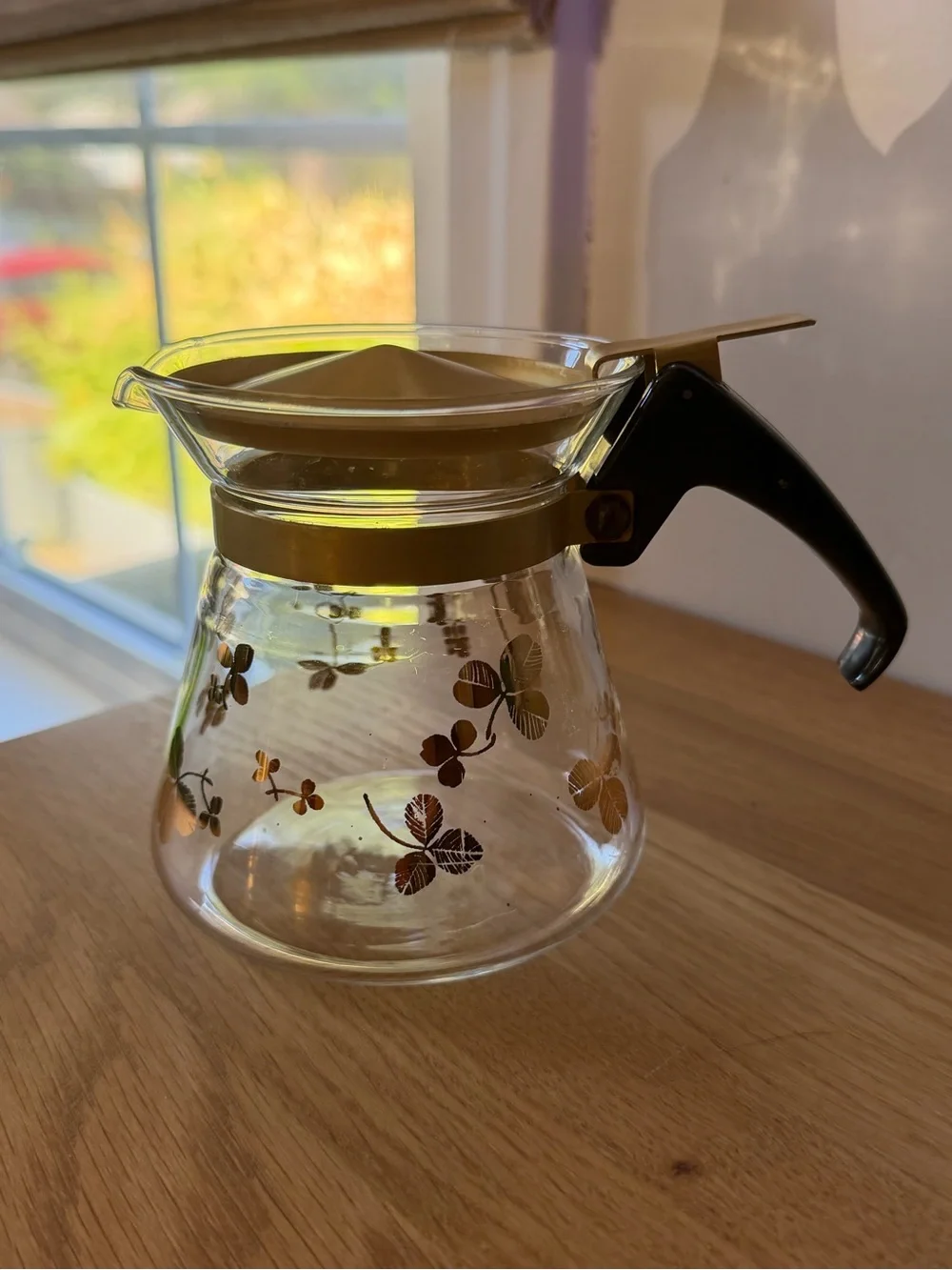 Glass Coffee Carafe with Gold Floral Accents and Black Handle